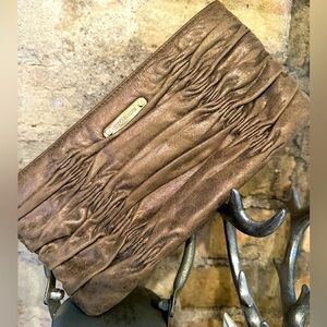 Micheal Kors Clutch in brushed gold free authentication included